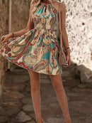 the DESERT BOHO - Women's Paisley Print Halter Dress with Adjustable Drawstring Neckline, Off-Shoulder Design, Vibrant Teal Blue & Beige Floral Print Pattern, Lightweight Polyester Fabric, Perfect for Spring/Summer Vacations, Cute Dresses